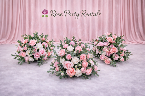 Three pink rose arrangements on blush drape