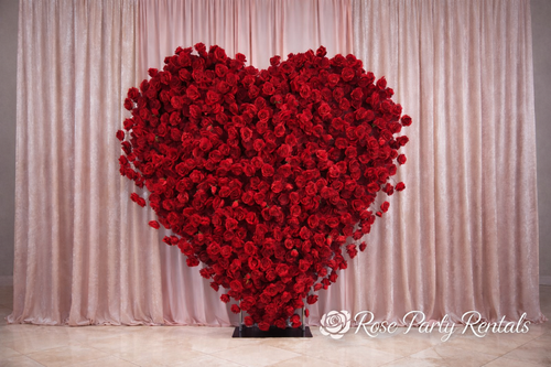 Red rose heart sculpture on blush drape