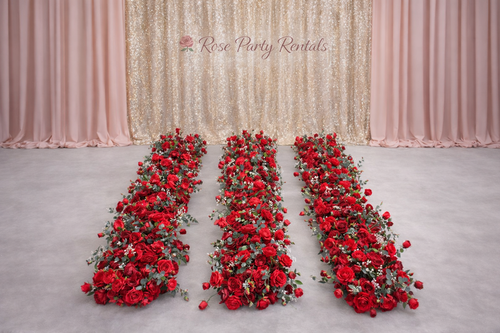 Red rose floral runners on champagne backdrop